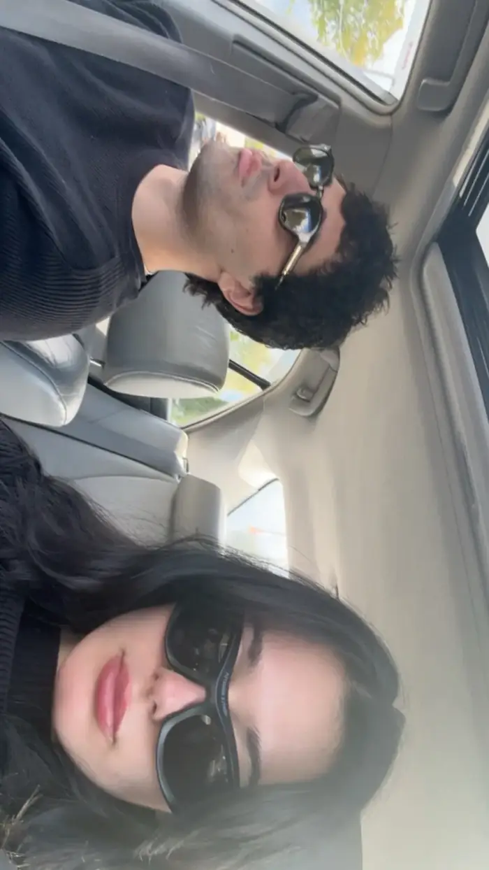 the same car selfie a third time, phone turned sideways