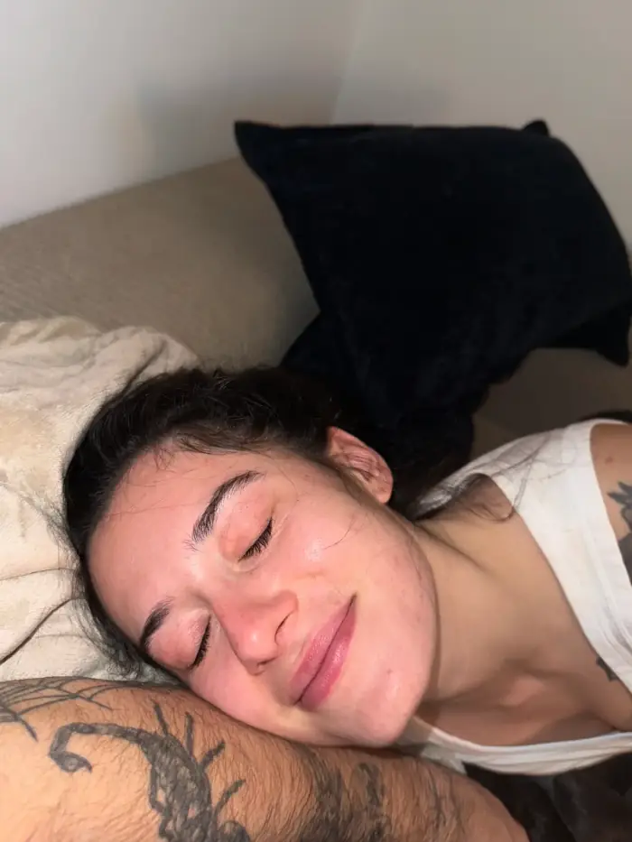 olivia asleep on his shoulder, his tattooed arm in the corner of the frame