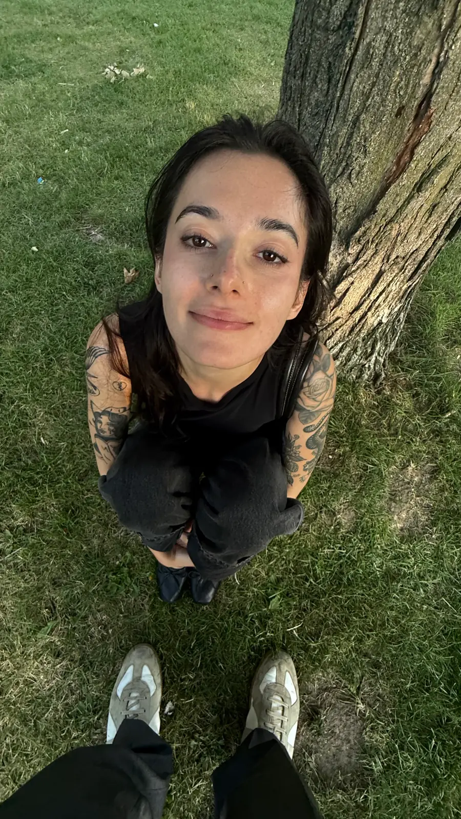 you on the grass under a tree, looking straight up into the camera